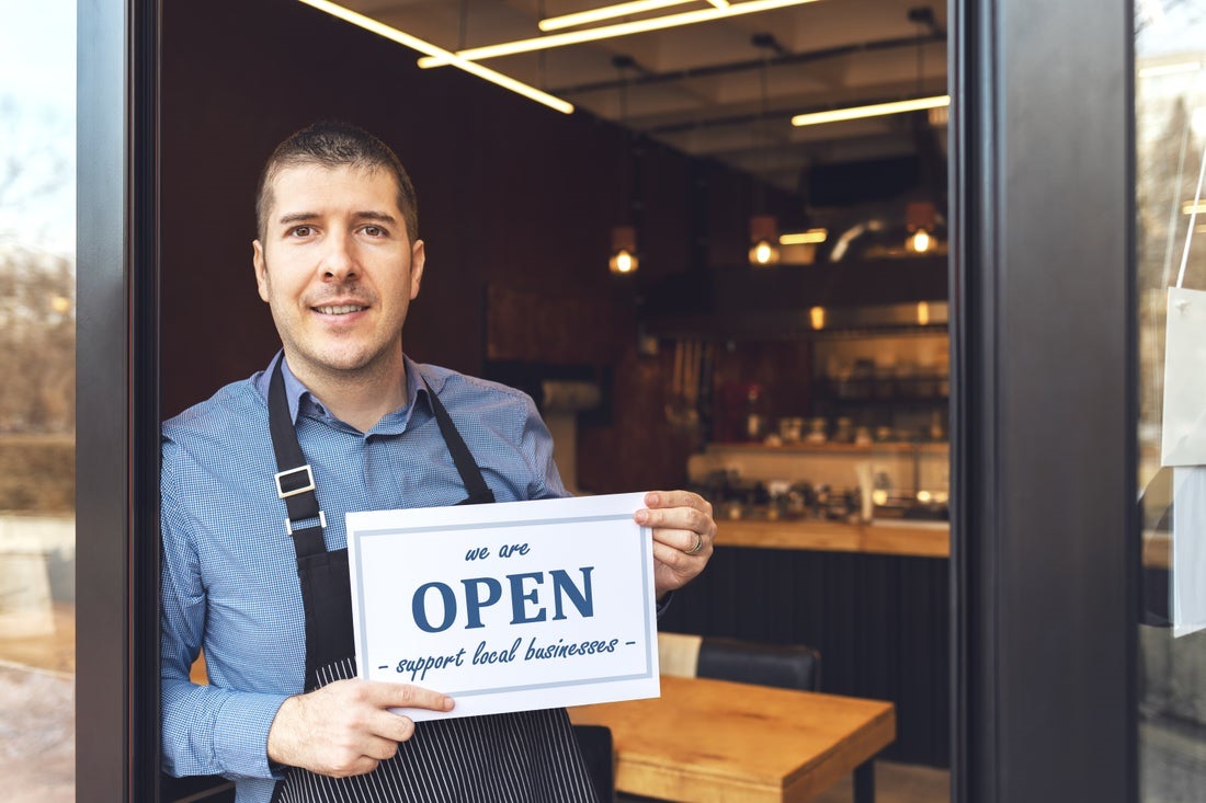 man holding open sign