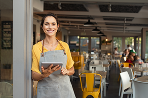 female business owners standing in doorway of coffee shop