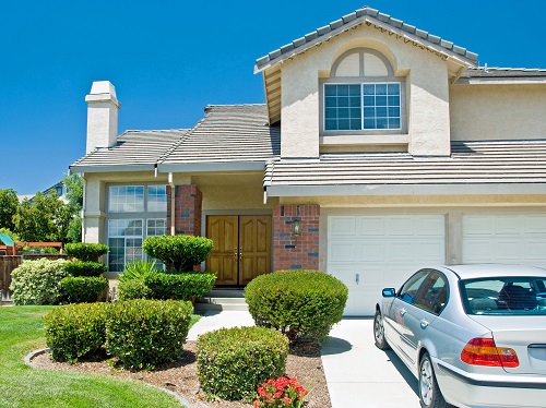 exterior of house with silver car parked outside garage